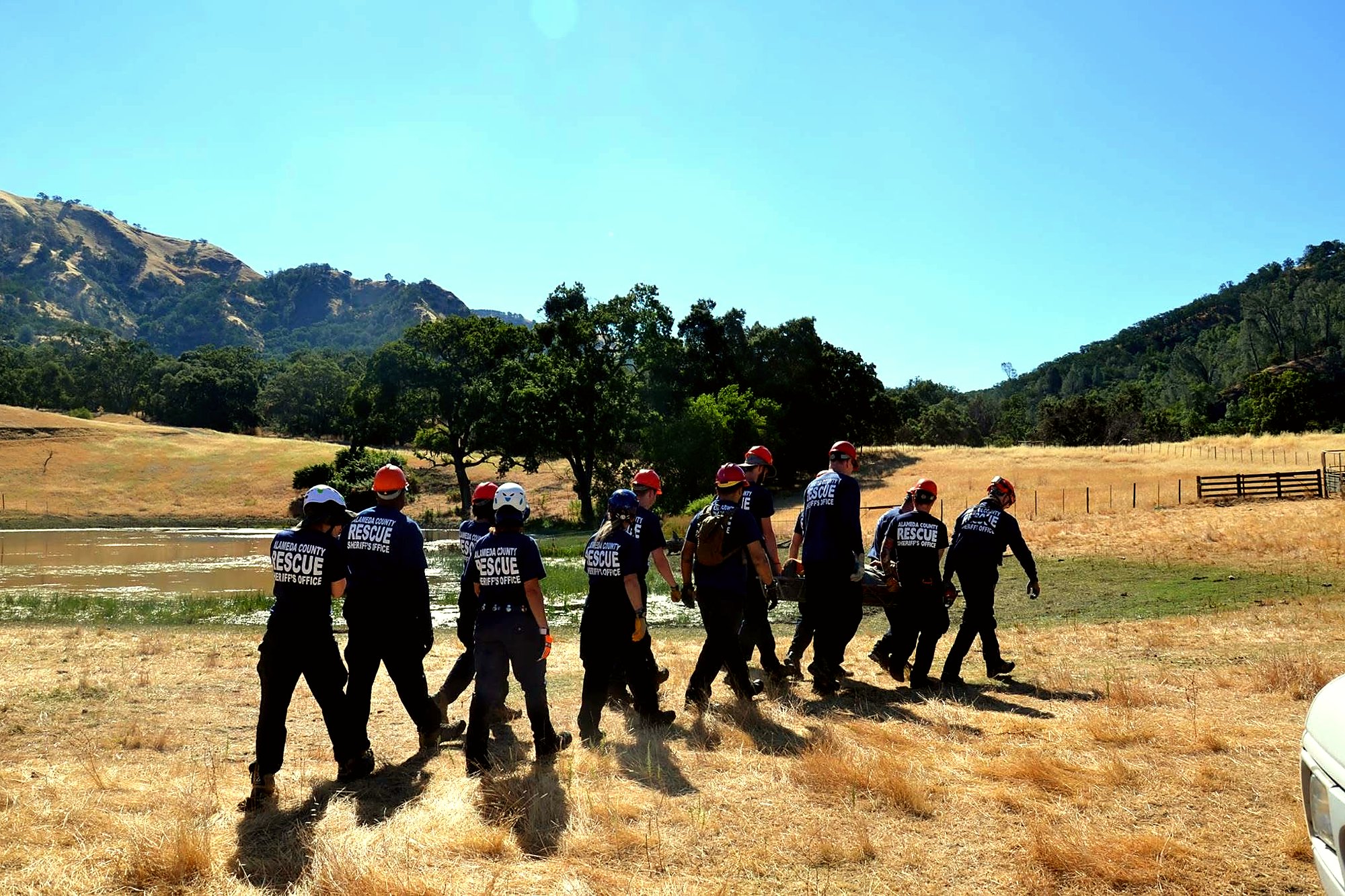 Alameda County Search and Rescue team carrying a litter across a field